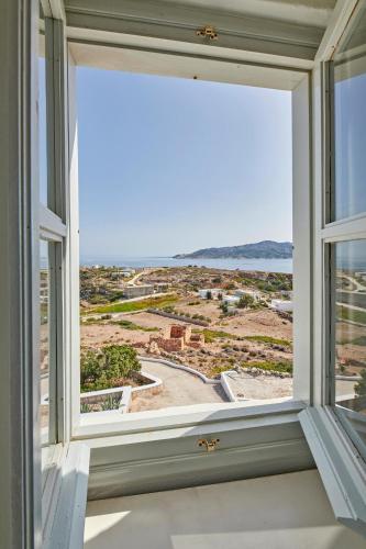 an open window with a view of the ocean at The Windmill Kimolos in Kimolos