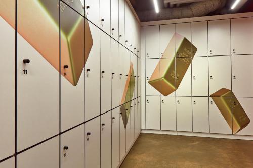 a locker room with umbrellas on the wall at CityHub Copenhagen in Copenhagen