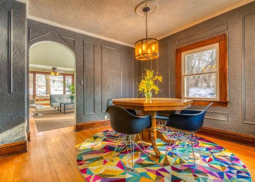 a dining room with a table and chairs on a rug at Secluded Fenced Cottage W Dune Top Hot Tub Near Hiking Dog Friendly in Miller