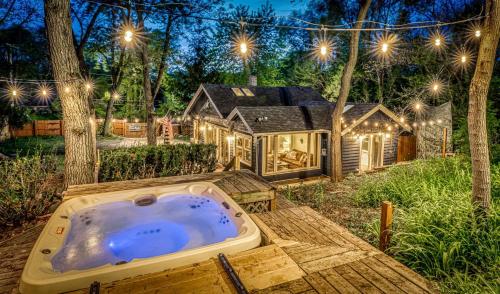 a jacuzzi tub in the backyard of a house at Secluded Fenced Cottage W Dune Top Hot Tub Near Hiking Dog Friendly in Miller