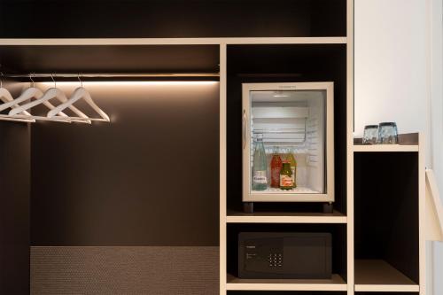 a refrigerator with its door open in a kitchen at INNSiDE by Meliá Newcastle in Newcastle upon Tyne