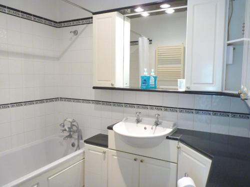 a bathroom with a sink and a bath tub at Secret Garden Hideaway For Adults in Eastbourne