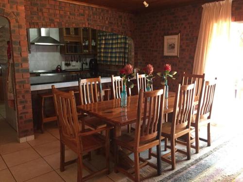 - une table à manger et des chaises fleuries dans la cuisine dans l'établissement Mark's View, à KwaDukuza