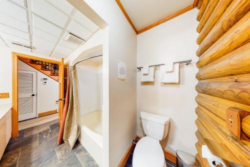 a small bathroom with a toilet and a shower at River Bend Lodge in Washougal