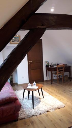 a living room with a coffee table and a desk at La Merlette89 in Lailly