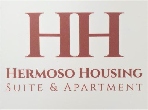 a sign for the hermoso housing suite and apartments at HH Hermoso Housing VIA PAIETTA in Valenza