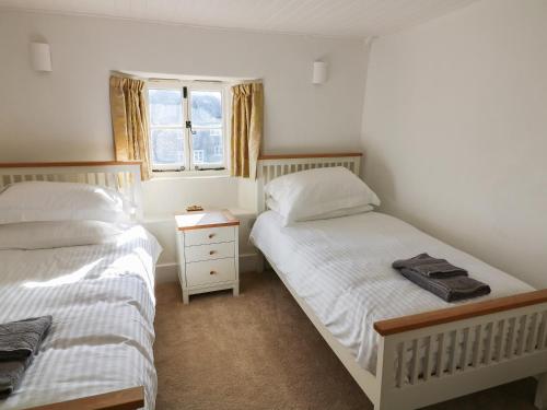 Un pat sau paturi într-o cameră la Furneaux Hatch