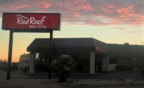 a red and white sign in front of a restaurant at Red Roof Inn & Suites San Angelo in San Angelo