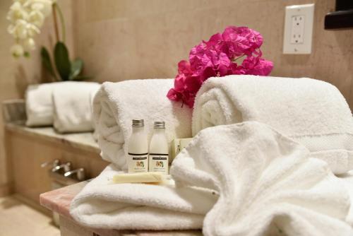 a pile of towels on a table in a bathroom at Princess Heights Luxury Condo Hotel in Dawn Beach