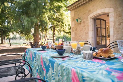 a table with a blue table cloth with food on it at Domaine Cap Rubis in Paradou