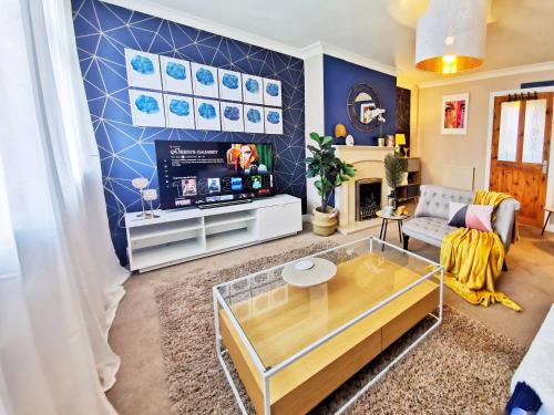 a living room with a couch and a tv at Highstone 4 Bedrooms Home 7 Beds With Parking and Garden in Barnsley