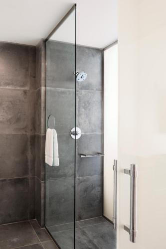 a shower with a glass door in a bathroom at Jupiter NEXT in Portland