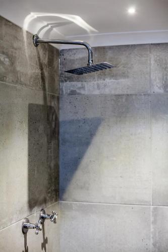 a shower with a shower head in a bathroom at 1926 Self Catering in Piketberg