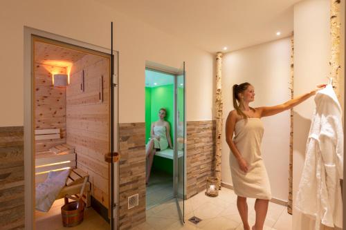 a woman in a white dress in a bathroom at Kohlers Hotel Engel in Bühl