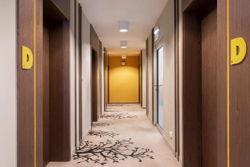 a corridor of a hallway with trees painted on the floor at Villa Buki Pokoje & SPA in Jastrzębia Góra
