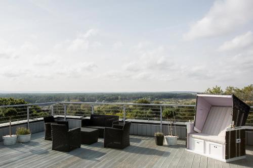 a balcony with furniture and a view of the countryside at Villa Buki Pokoje & SPA in Jastrzębia Góra