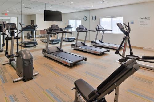 a gym with several tread machines in a room at Holiday Inn Express & Suites Trinity by IHG in Trinity