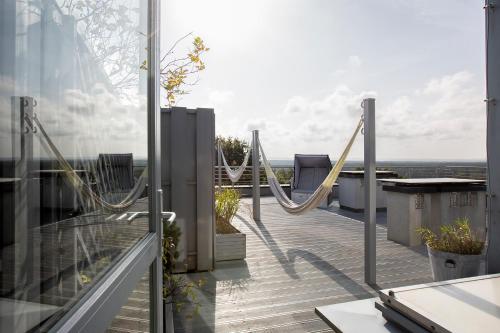 a balcony with hammocks on top of a building at Villa Buki Pokoje & SPA in Jastrzębia Góra