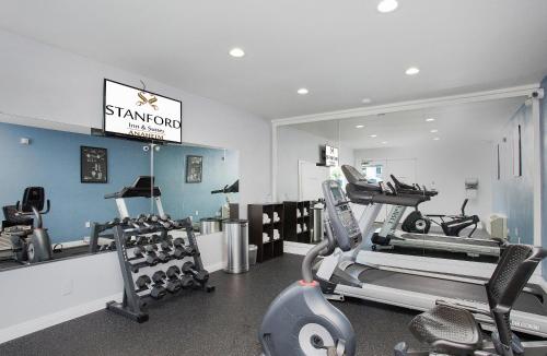 a gym with treadmills and machines in a room at Stanford Inn & Suites Anaheim in Anaheim
