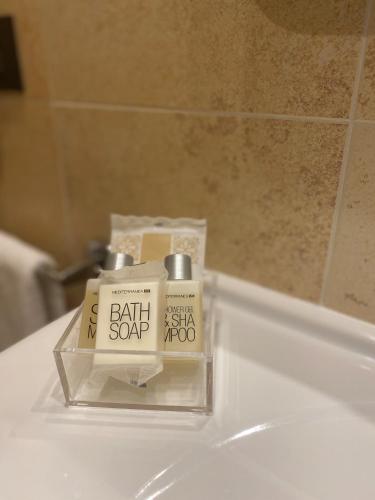 a bathroom sink with a box of bath soap on it at MH Hotel Piacenza Fiera in Piacenza