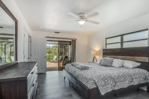 a bedroom with a bed and a ceiling fan at Barsl Retreat in Cape Coral