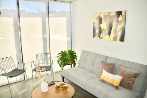 a living room with a couch and a table at Cozy Stays Cayala Apartments 3 in Guatemala