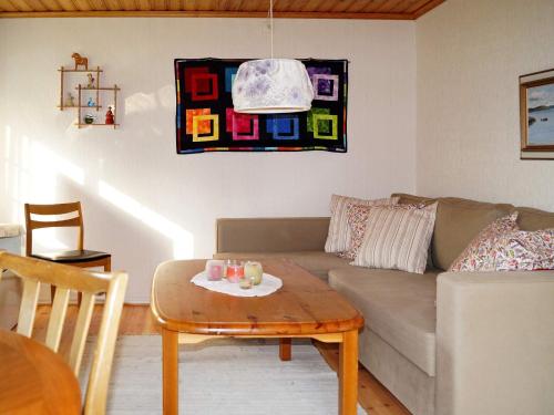 a living room with a couch and a table at One-Bedroom Holiday home in Hjältevad in Svenstorp