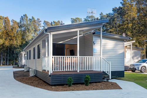 a mobile home with a porch on a driveway at Discovery Parks - Gerroa in Gerroa