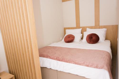 a bedroom with a bed with two pillows on it at Urban Residence Apartments in Mostar