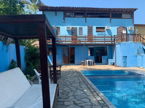 a villa with a swimming pool and a house at POUSADA BELLA SPIAGGIA in Paraty