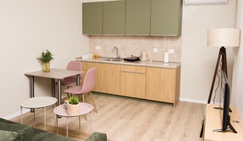a kitchen with a sink and a table and chairs at Urban Residence Apartments in Mostar