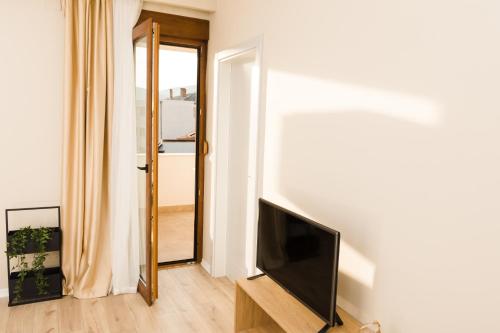 a living room with a flat screen tv on a wall at Urban Residence Apartments in Mostar