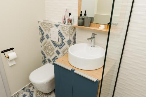 a bathroom with a sink and a toilet at Urban Residence Apartments in Mostar