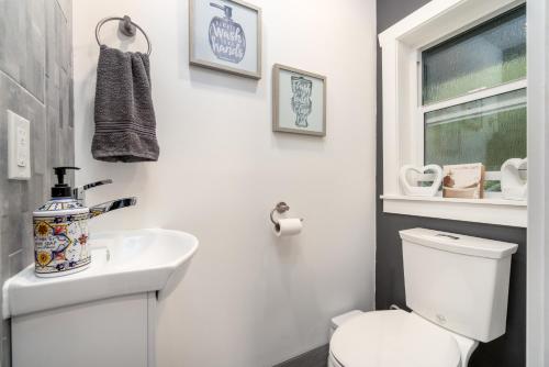 a bathroom with a white toilet and a sink at Amante Luxury Bed & Breakfast in Victoria