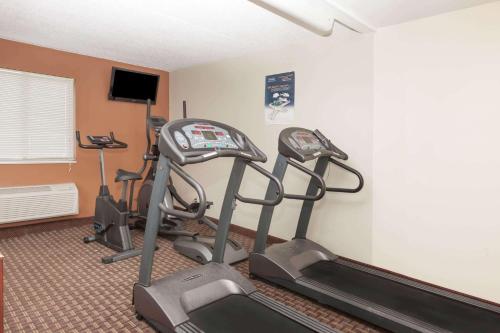 a room with three exercise bikes in a room at Travelodge Inn & Suites by Wyndham Albany in Albany