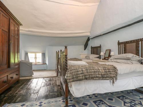 a bedroom with two beds and a ceiling at Hole Farm in Gidleigh