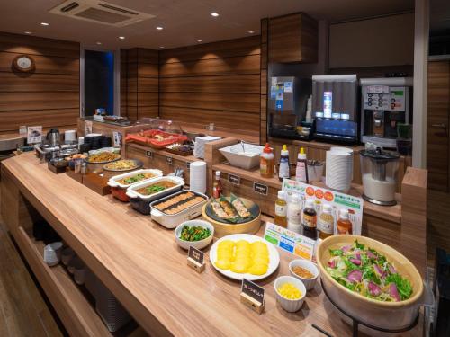 a buffet line with many different types of food at Super Hotel JR Fujiekimae Kinenkan in Fuji