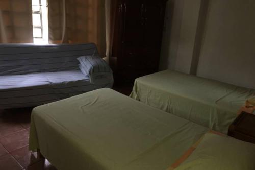 a room with two beds and a window at Chacala Sol y Luna 6 pax con ALBERCA a solo 50 mts de playa in Chacala