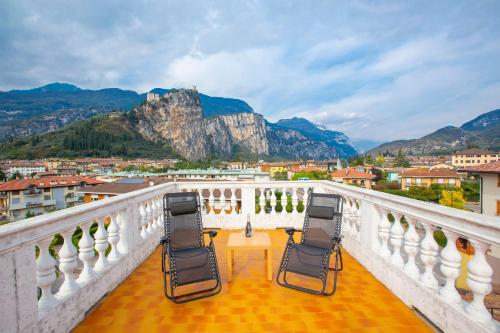 two chairs on a balcony with a view of mountains at Casa Franco e Ilva - Happy Rentals in Arco