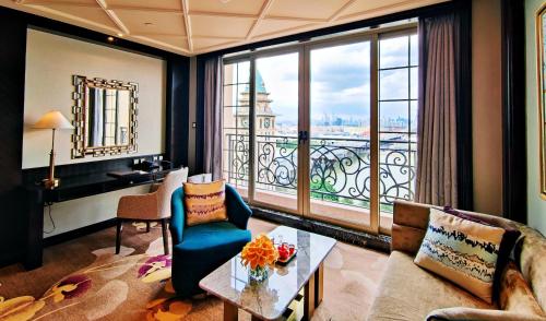 a living room with a view of the city at Chateau Star River Guangzhou-Free Shuttle Between Hotel And Exhibition Center & Welcome Drink During Canton Fair in Guangzhou