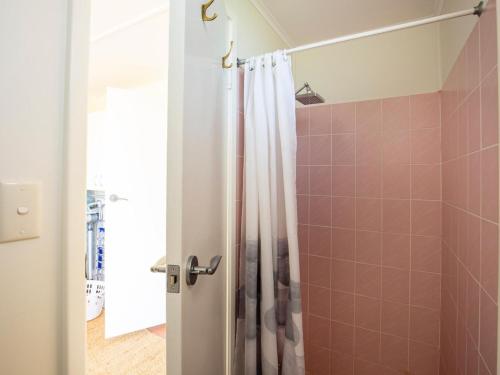 a bathroom with a shower with a shower curtain at Pagoda at Culburra I Pet Friendly I Newly Renovated in Culburra Beach
