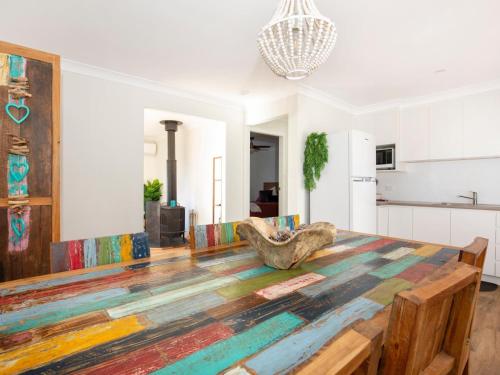 a living room with a table and a kitchen at Pagoda at Culburra I Pet Friendly I Newly Renovated in Culburra Beach