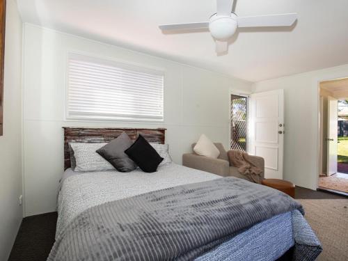 a bedroom with a large bed and a window at Pagoda at Culburra I Pet Friendly I Newly Renovated in Culburra Beach