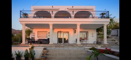 a white house with a balcony on top of it at Maison Alriad - Alojamiento familiar tranquilo cerca del mar con jardín, porche y parking privado en el interior de la finca no apto para fiestas in Mojácar