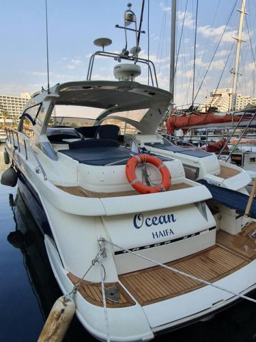 a white boat tied to a dock in the water at Red Sea Yachts in Eilat