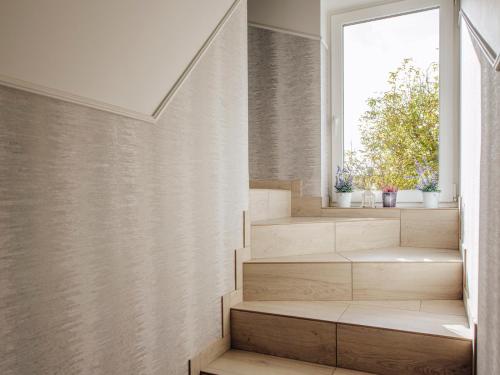 a staircase in a house with a window at Willa Lawenda in Ciechocinek