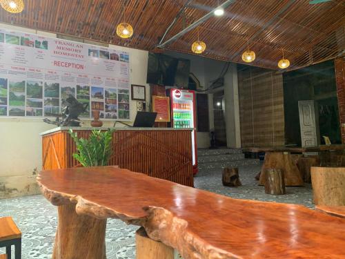 a large wooden table in a restaurant with a counter at Trang An Memory Homestay in Ninh Binh