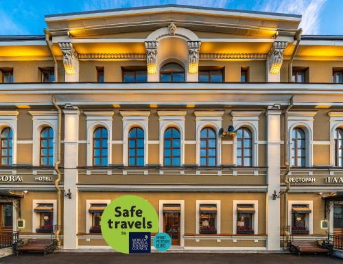 um grande edifício com um sinal de venda de viagens em frente dele em Boutique Hotel Albora em São Petersburgo
