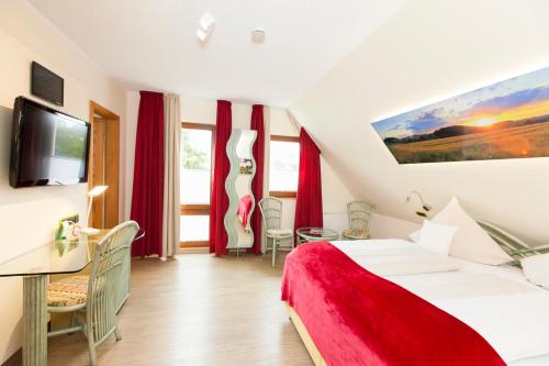 a hotel room with a bed and a tv at Landgasthof Tönnes in Wipperfürth