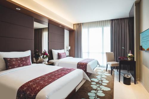 Ένα ή περισσότερα κρεβάτια σε δωμάτιο στο The Margo Hotel